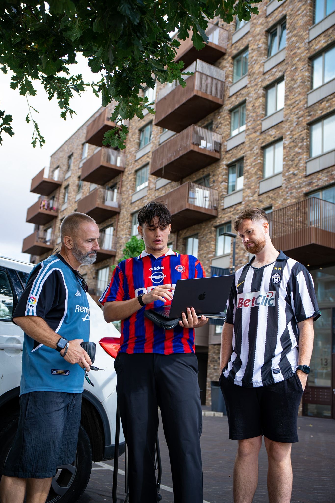 Jason Murray and the FC Classico team inspecting a football shirt